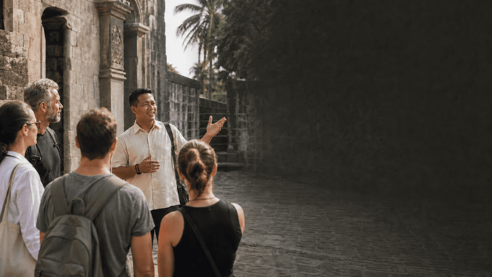 A Filipino tour guide bringing the history of Intramuros to life for international visitors